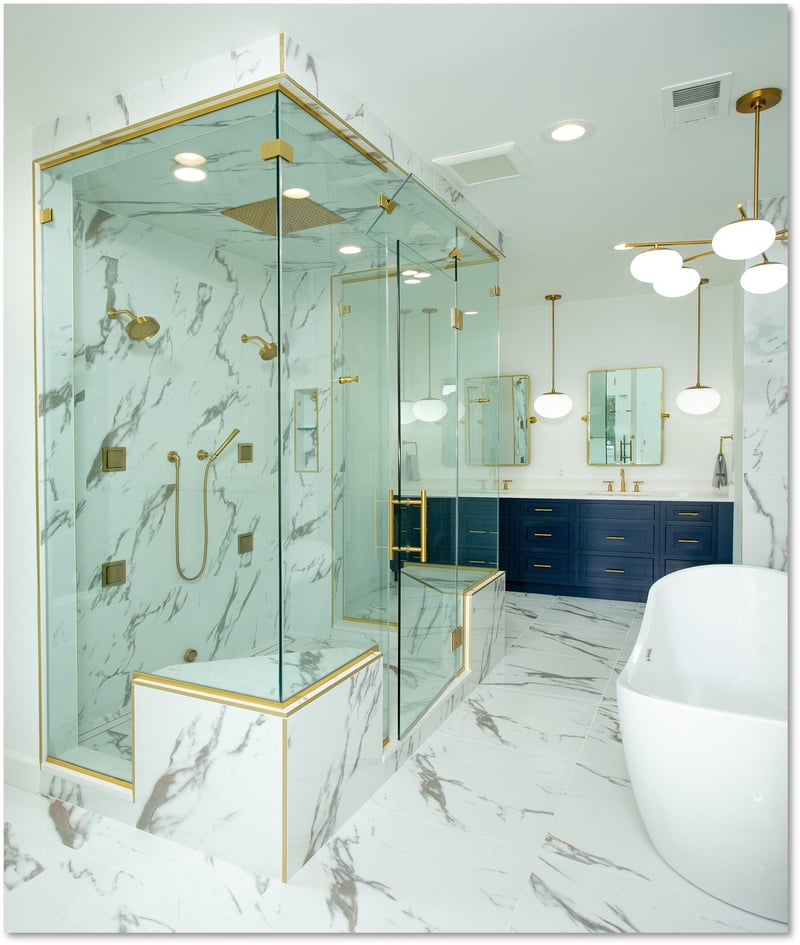 Experience award-winning design in this luxurious Potomac bathroom, featuring white and gray marble walls and floors, a sleek freestanding bathtub, modern gold-accented fittings, a glass-enclosed shower, and a contemporary chandelier.