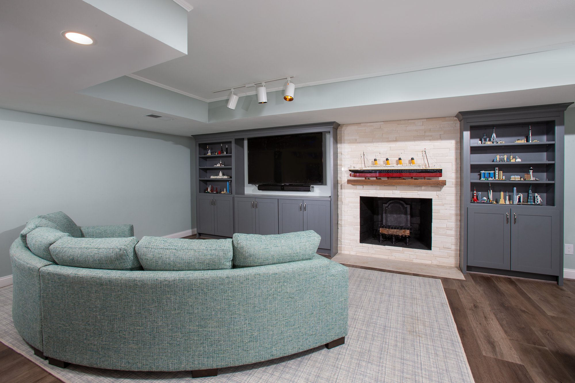 <img alt="A cozy living room with a curved teal sectional sofa facing an award-winning fireplace and TV. Built-in shelves on either side of the fireplace display small collectibles. The room features light blue walls and wood flooring—Smiley Renovations at its best." src="#" /> <img alt="A cozy living room with a curved teal sectional sofa facing an award-winning fireplace and TV. Built-in shelves on either side of the fireplace display small collectibles. The room features light blue walls and wood flooring—Smiley Renovations at its best." src="#" />