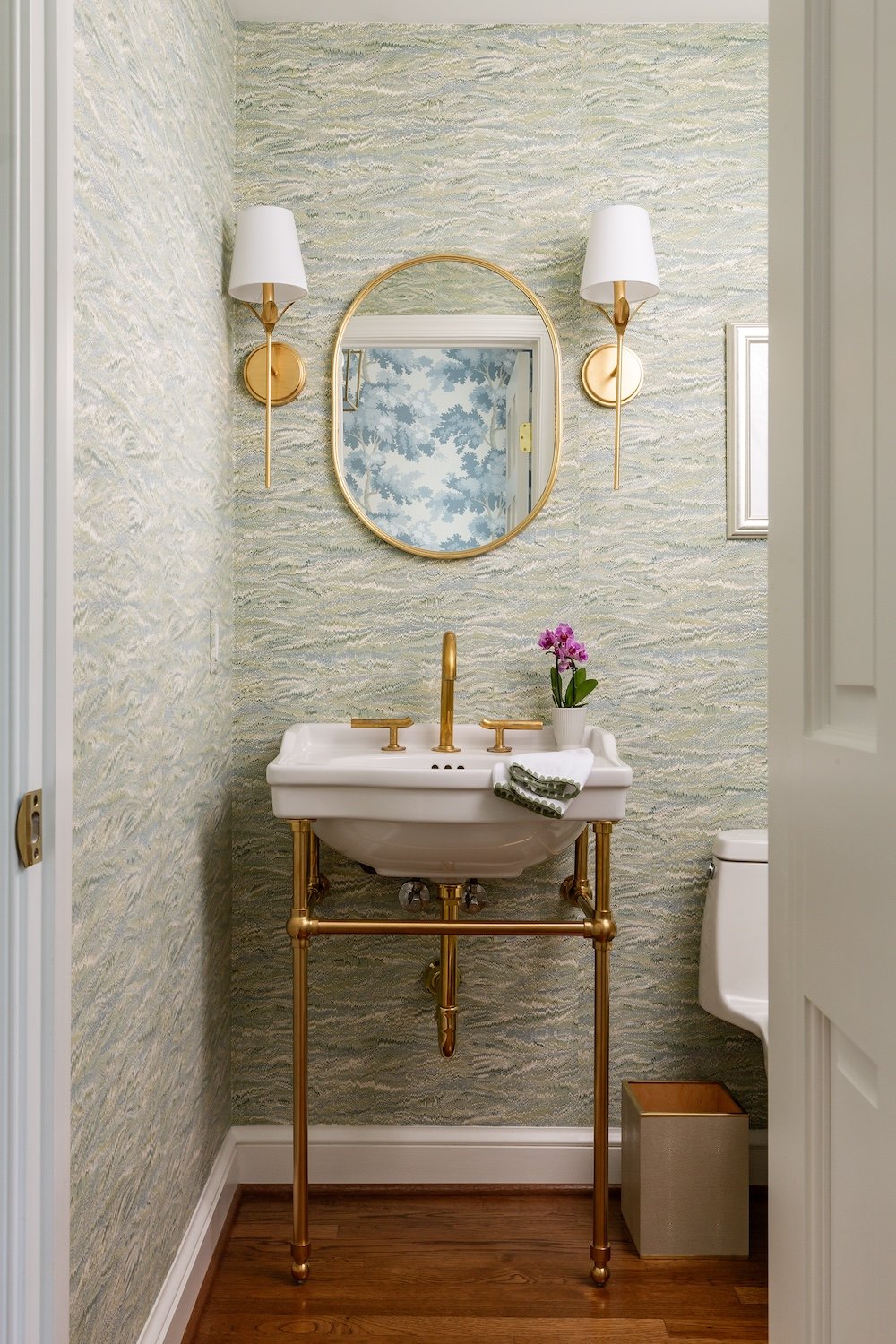 <img alt="A small powder room in Northwest DC features green marbled wallpaper, a white sink with gold fixtures and stand, a round gold-framed mirror, wall sconces, wood floor, toilet, and a small potted plant. Designed by an award-winning remodeler." src="#" /> <img alt="A small powder room in Northwest DC features green marbled wallpaper, a white sink with gold fixtures and stand, a round gold-framed mirror, wall sconces, wood floor, toilet, and a small potted plant. Designed by an award-winning remodeler." src="#" />