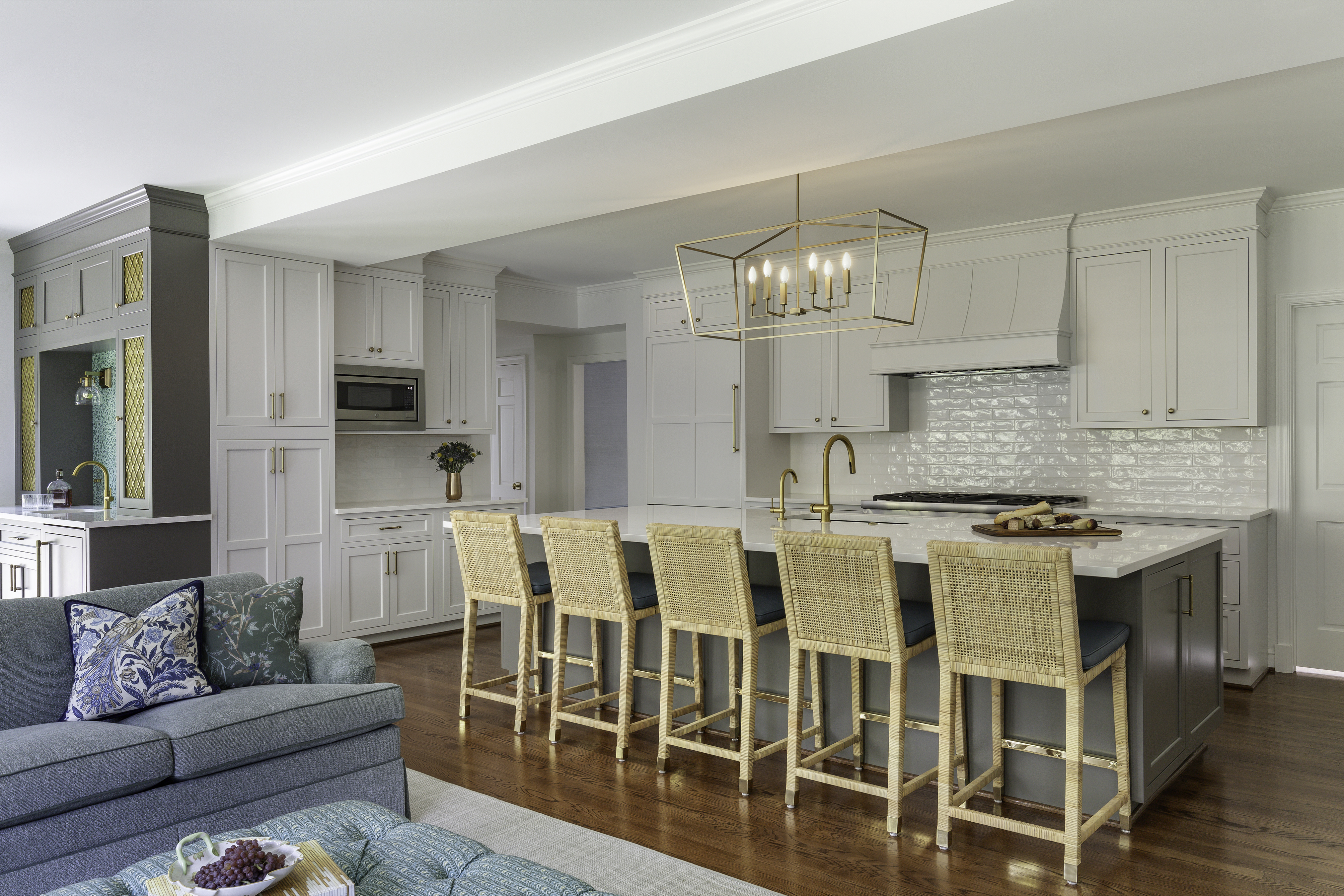 A kitchen featuring a dining table and couches, with interior design elements such as cabinetry, countertops, and a floor. The space includes items like chairs and decorative pieces, creating a cozy home atmosphere.